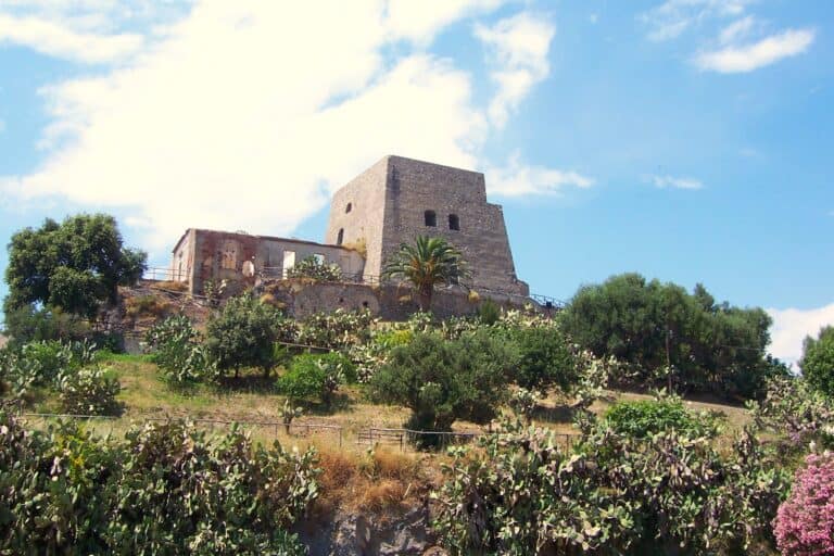 16th century watch tower known as Torre Talao on a hill with trees and plants in Scalea.