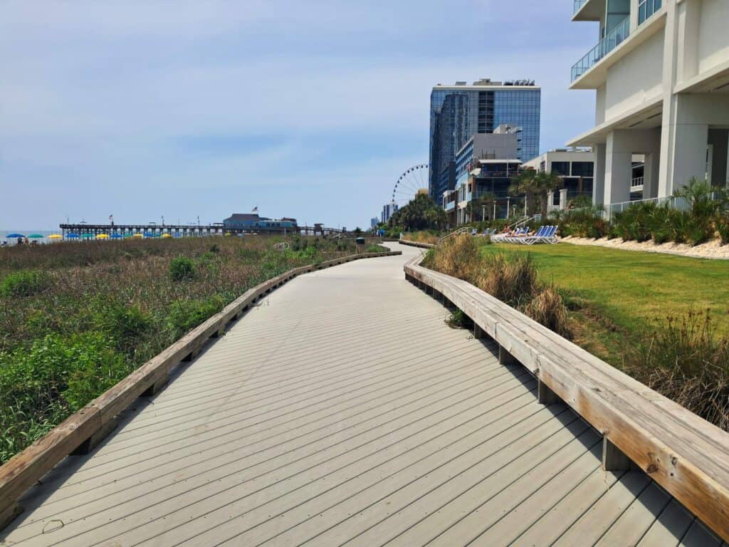 Beginning of the Myrtle Beach Boardwalk along the sea grass on the beach.