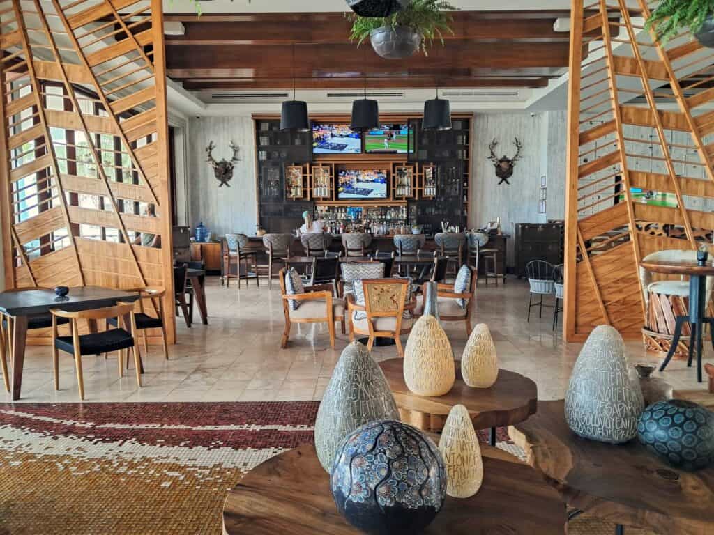 Interior view of the Sotol Tequila Bar with artwork, sports on the TVs on the far wall in the Hilton Los Cabos.