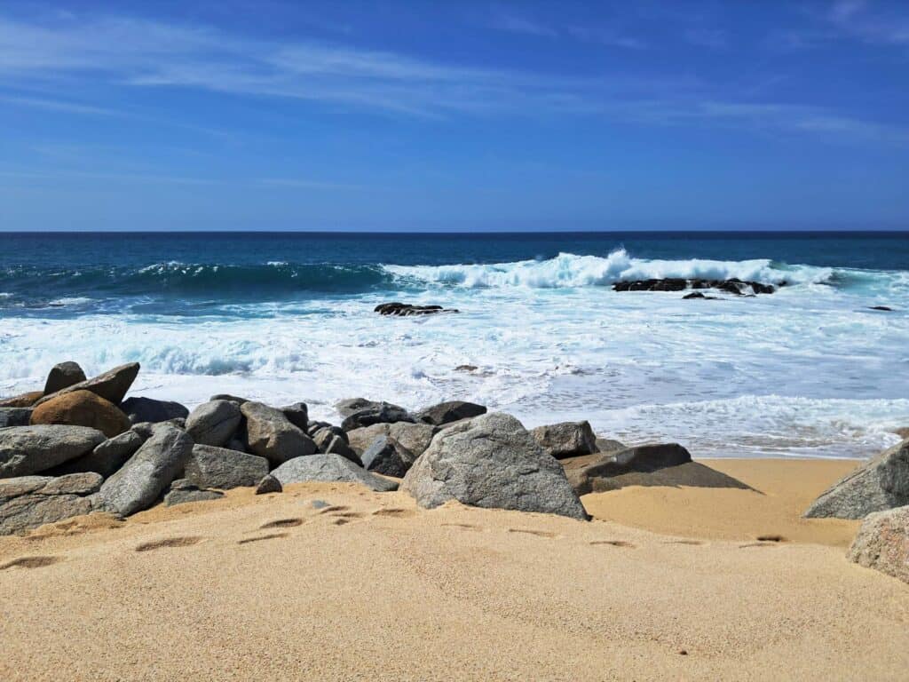 Waves form in the sea and crash against the rocks along the Hilton Los Cabos beach.