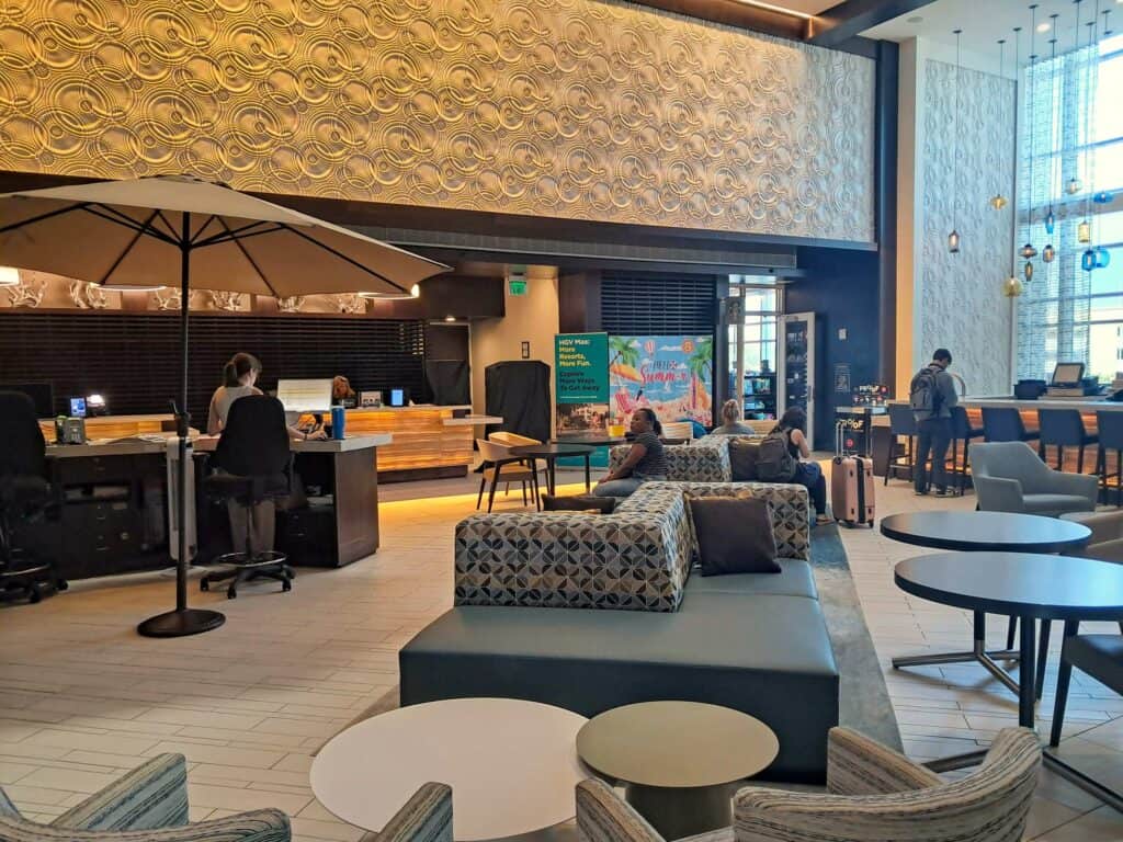 Hilton Ocean 22 lobby on 2nd floor with seating, bar, and check-in counters.