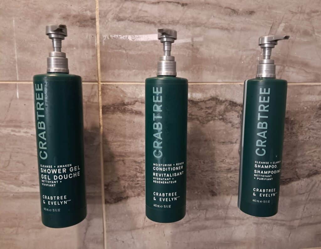 Crab Tree & Evelyn body gel, shampoo, and conditioner in the shower.