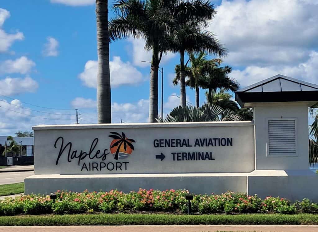 Entrance sign to the Naples Airport.