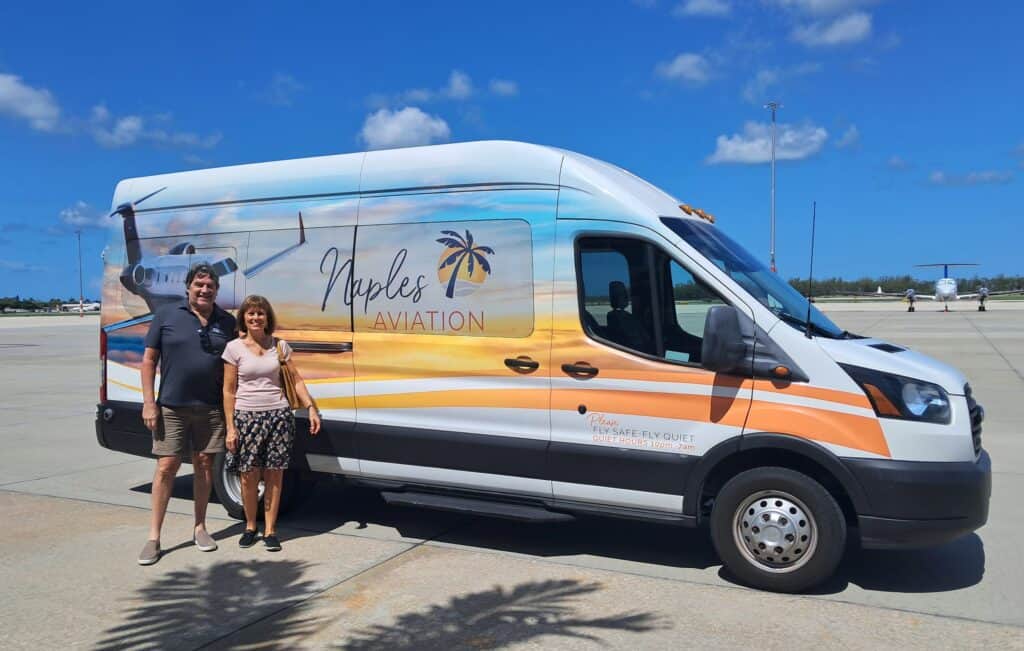 Shuttle van used for the Naples airport tour with Janet and Stuart standing near the van.