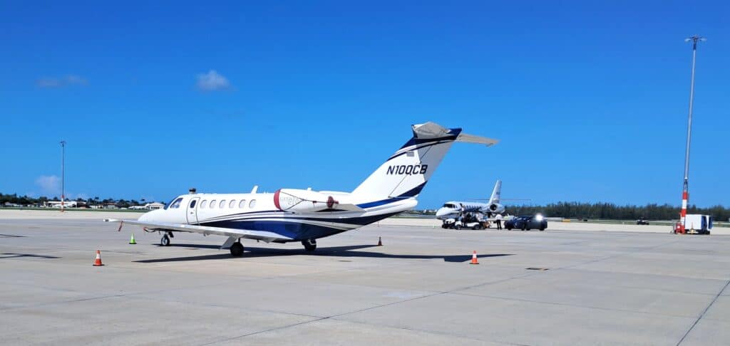 Two private jets loading passengers on the tarmac at the Naples Airport.
