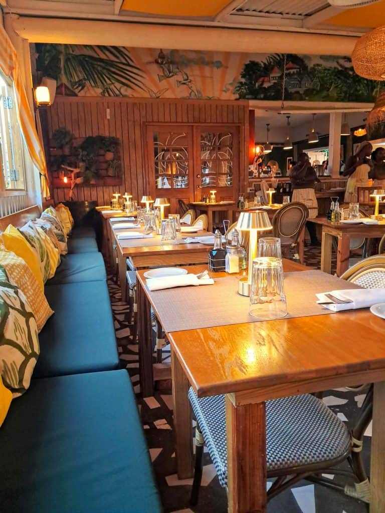 Interior view of the dining tables and bar at Le Shack restaurant.