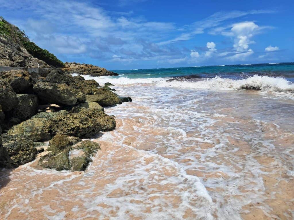 The Crane Beach with waves crashing against the rocks.