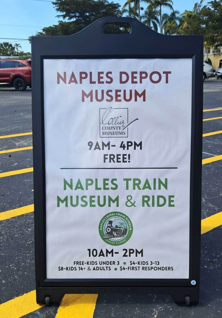 Sign with Naples Depot Museum and Naples Train Museum & Ride hours and cost.