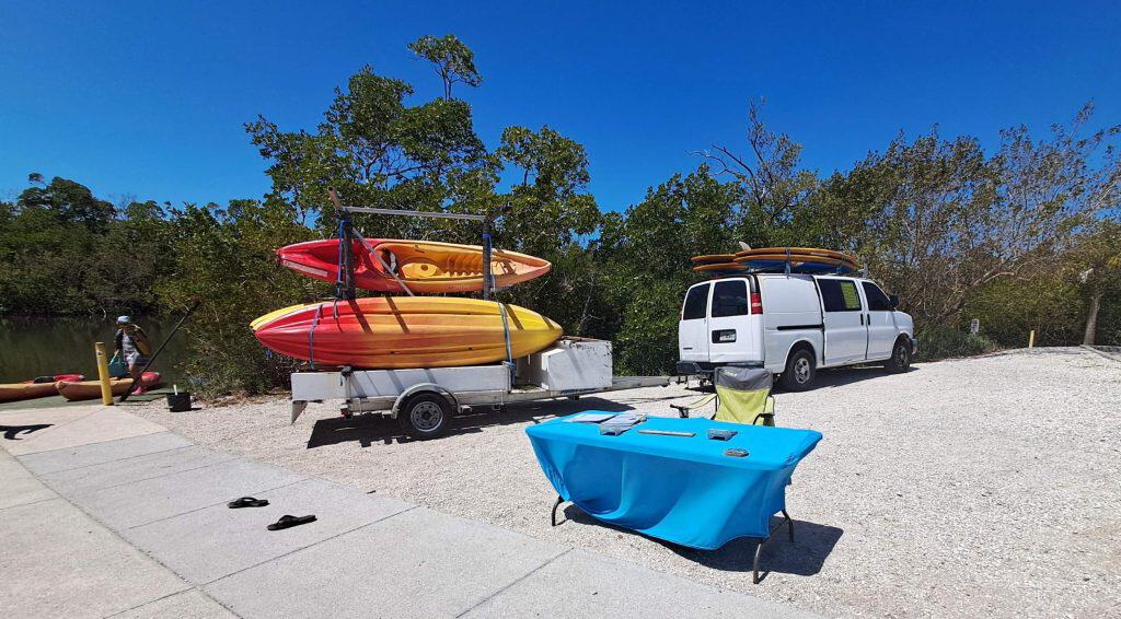 Kayaks on the trailer next to the check-in table.