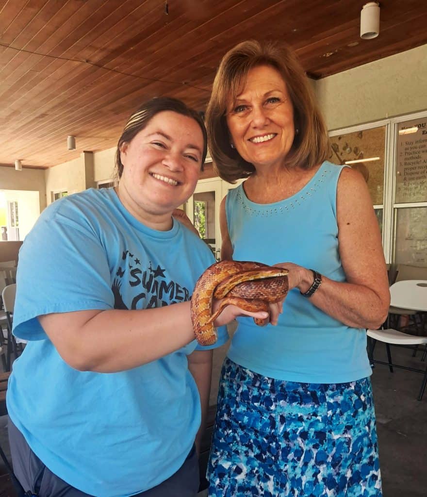Kelly and Janet holding a corn snake.