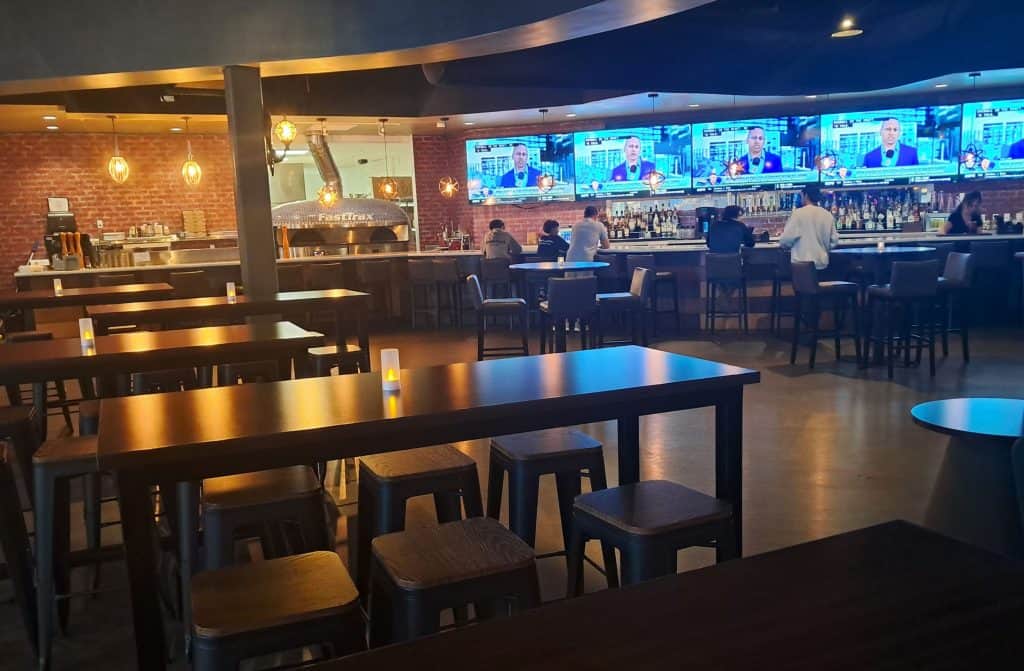Restaurant and bar with TV screens near the multi-level racetracks.