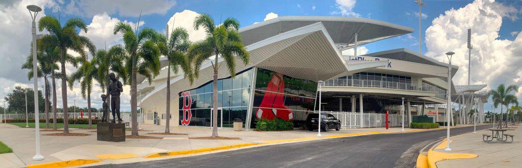 Entrance to the JetBlue stadium with 2 red soxs on the glass window.