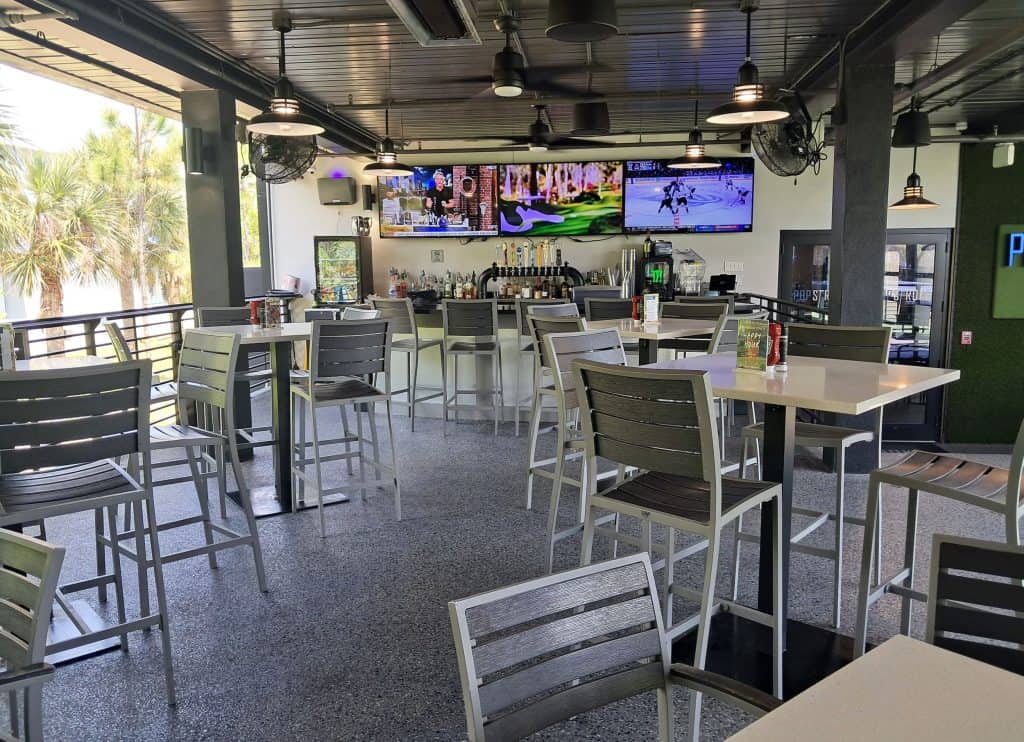 Restaurant and bar with TV screens on the back wall at PopStroke.