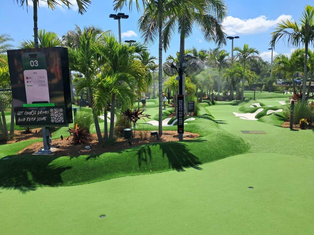 Fairway and green with palm trees at PopStroke in Fort Myers.