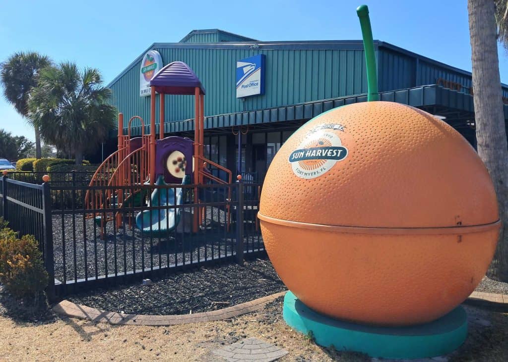 Exterior of the Sun Harvest Citrus store with a large orange in front.