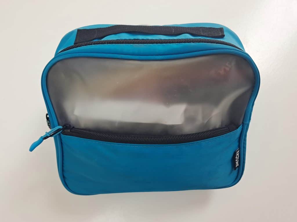 Teal toiletry bag with a black handle and a zipper compartment in the front.